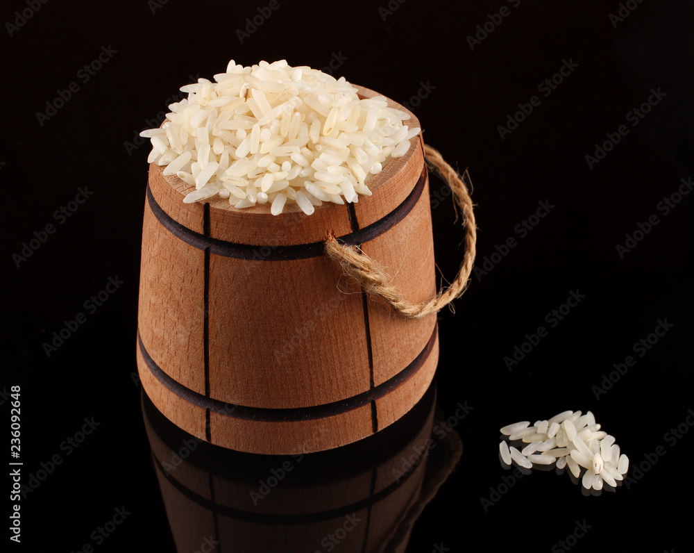 Canvas Prints Barrel with rice on a dark background