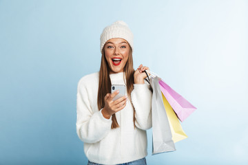 Cheerful young woman wearing sweater standing