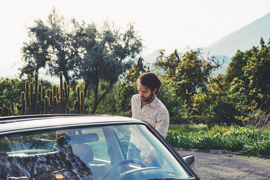 Mid adult man by Mercedes-Benz car