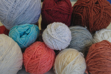Knitting, needlework. Colored balls of yarn in a basket, knitting needles.
