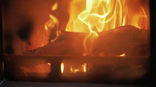 Slow dolly shot in to stove fire flames