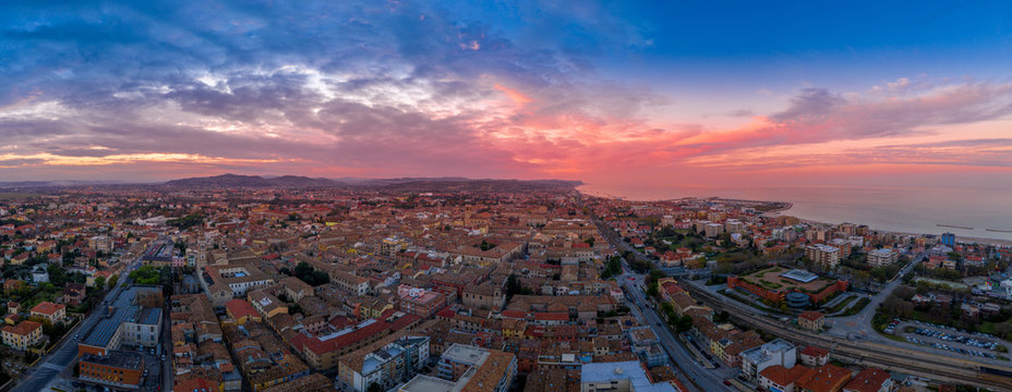 Aerial panorama of popular travel destination beach town Fano in Italy with sunset blue, red, purple sky near Rimini in the Marche region.