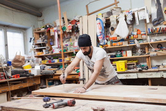 Carpenter using a drill in Sweden