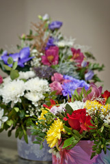 colored flowers in the basket on the table