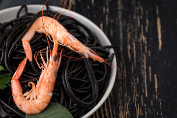 Black spaghetti with prawns. Homemade.