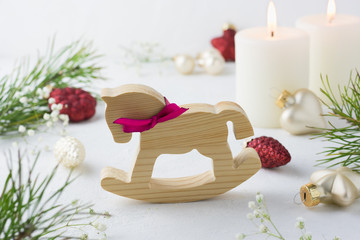 Christmas wooden horse, fir branch, stars, cone, decoration