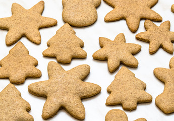 Home-baked gingerbread on a kitchen surface with baking paper - Christmas concept with home-baked cookies in the kitchen