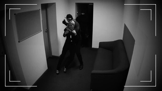 Thieves with woman hostage escaping from place of crime, surveillance camera 