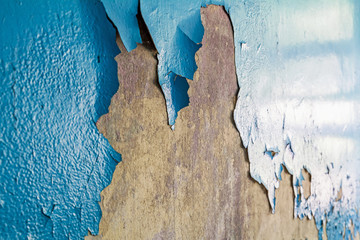 Cracked wall with old layers of paint in abandoned house