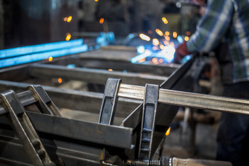 Metal construction on the stocks is processed by the welder