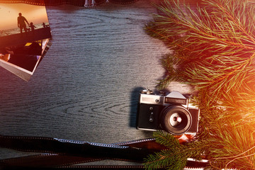 Top View of Vintage Camera Between Christmas decorations, Christmas tree, warm and cold toning,...