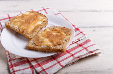 sandwiches with pollock roe on a white plate, on a white wooden background