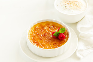 Creme brulee. dessert with caramel crust and berries.