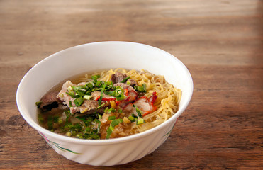 Noodle soup with red pork  and Pig liver. On top celery,Onion,pepper noodles Traditional Thai Street Foods.Put on the table.