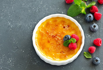 Creme brulee. dessert with caramel crust and berries.