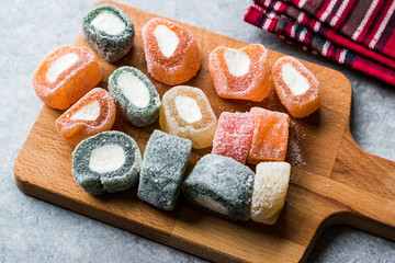 Fruity Turkish Delight Roll Shaped on Wooden Board.