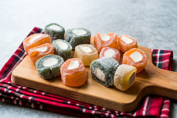 Fruity Turkish Delight Roll Shaped on Wooden Board.