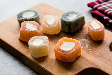 Fruity Turkish Delight Roll Shaped on Wooden Board.