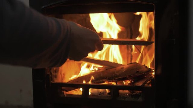 Adding a stick on the fire lovely stove SLOW MOTION