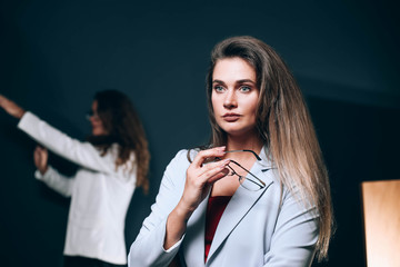  business woman with glasses in a white jacket on a blue background. Team .