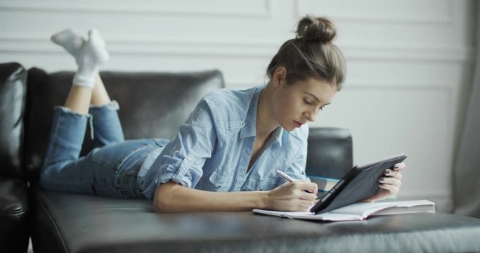 Young woman using digital tablet computer in home