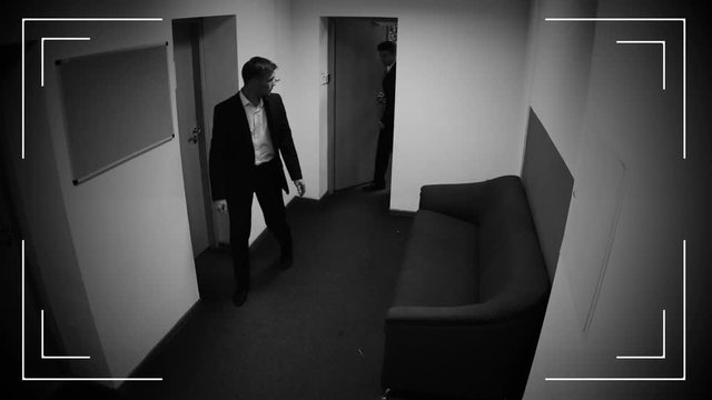 Businessman giving envelope with money to his partner, bribe, CCTV camera record