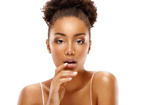 Attractive young woman touching her lips. Photo of african woman finishes makeup on white background. Youth and skin care concept