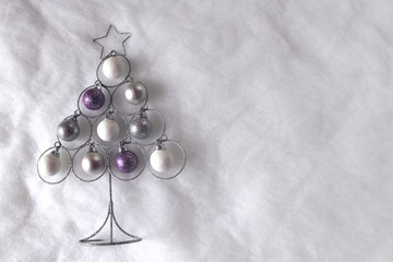 Christmas balls on a tree with snowy background
