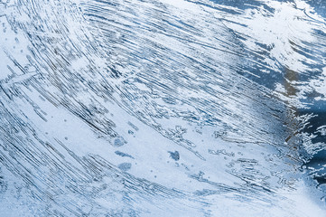 Winter background, frozen glass from strong frost, ice texture on the window