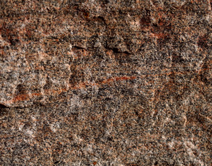 The structure of the natural is not polished granite brown with red veins. Natural background, cropped shot, close-up. The concept of nature and production.