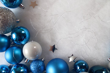 Silver and blue christmas balls on white snowy background