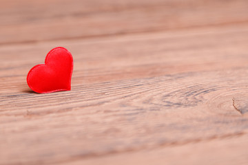 Fototapeta premium Valentine's day red heart on wooden background. Holidays background. Love card. Selective focus