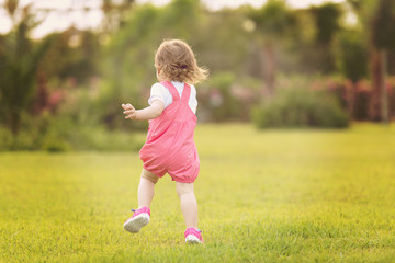 little girl spending time at backyard