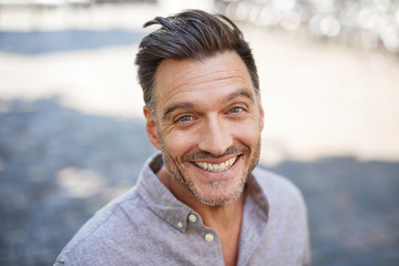 Portrait of laughing mature man with stubble