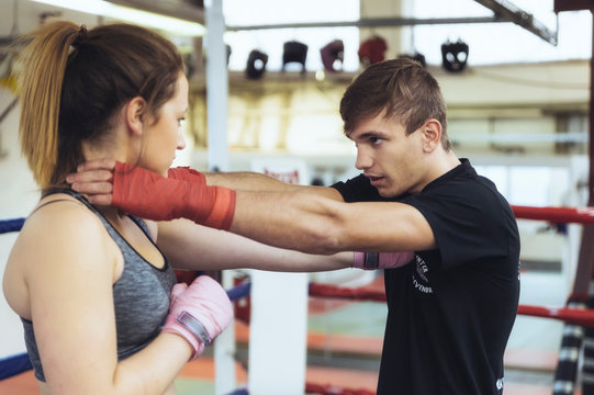 Female martial artist sparring with coach