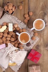 St. Nicolas day concept. Dutch holiday Sinterklaas, festive breakfast with coffee, kruidnoten, traditional sweets and presents. Top view. Free space for text.