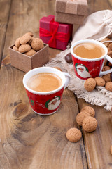 St. Nicolas day concept. Dutch holiday Sinterklaas, festive breakfast with coffee, kruidnoten, traditional sweets and presents. Top view. Free space for text.