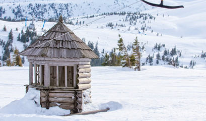 Wooden snow hut in winter