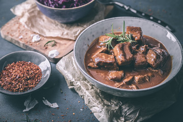 Delicious goulash with red cabbage chili and rosemary - obrazy, fototapety, plakaty