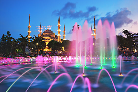 Blue Mosque with the fountain in the foreground, famous tourist destination in Istanbul, Turkey, on the first day of Ramadan with illuminated message which means "Welcome the sultan of eleven months".