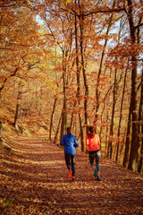 Fototapeta na wymiar Young woman running in autumn forest.