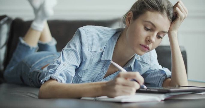 Young woman using digital tablet computer in home