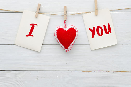 I Love You background. "I Love You". heart and note with words "I Love You". On white wood background. Flat lay conceps Valentines day