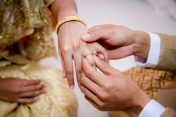 The groom wears a bridal ring.