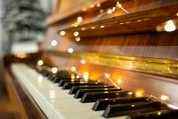 Piano keyboard with christmas light in the evening