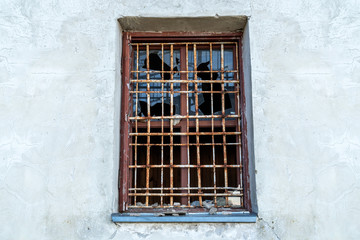 Broken glass window with bars