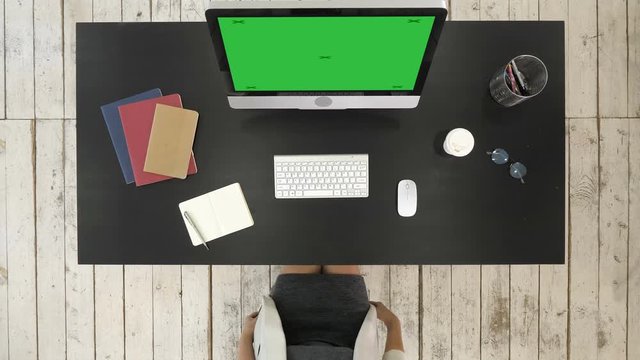 Businesswoman Working At Computer In Office. Green Screen Mock-up Display.