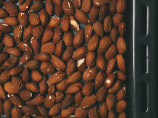 Almonds on a baking sheet. Preparation for biscotti cookies.