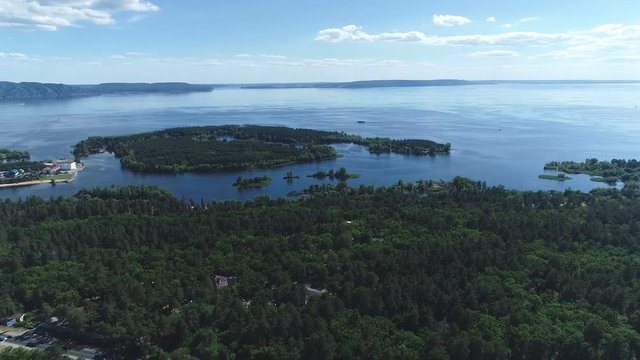 Aerial view of great river in summer during a flight. Boats moves on the river.