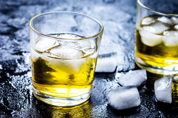 glass of whiskey on dark background